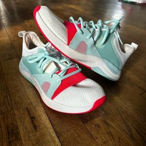 Stylish White and Teal Sneakers with Red Accents Under Armour brand